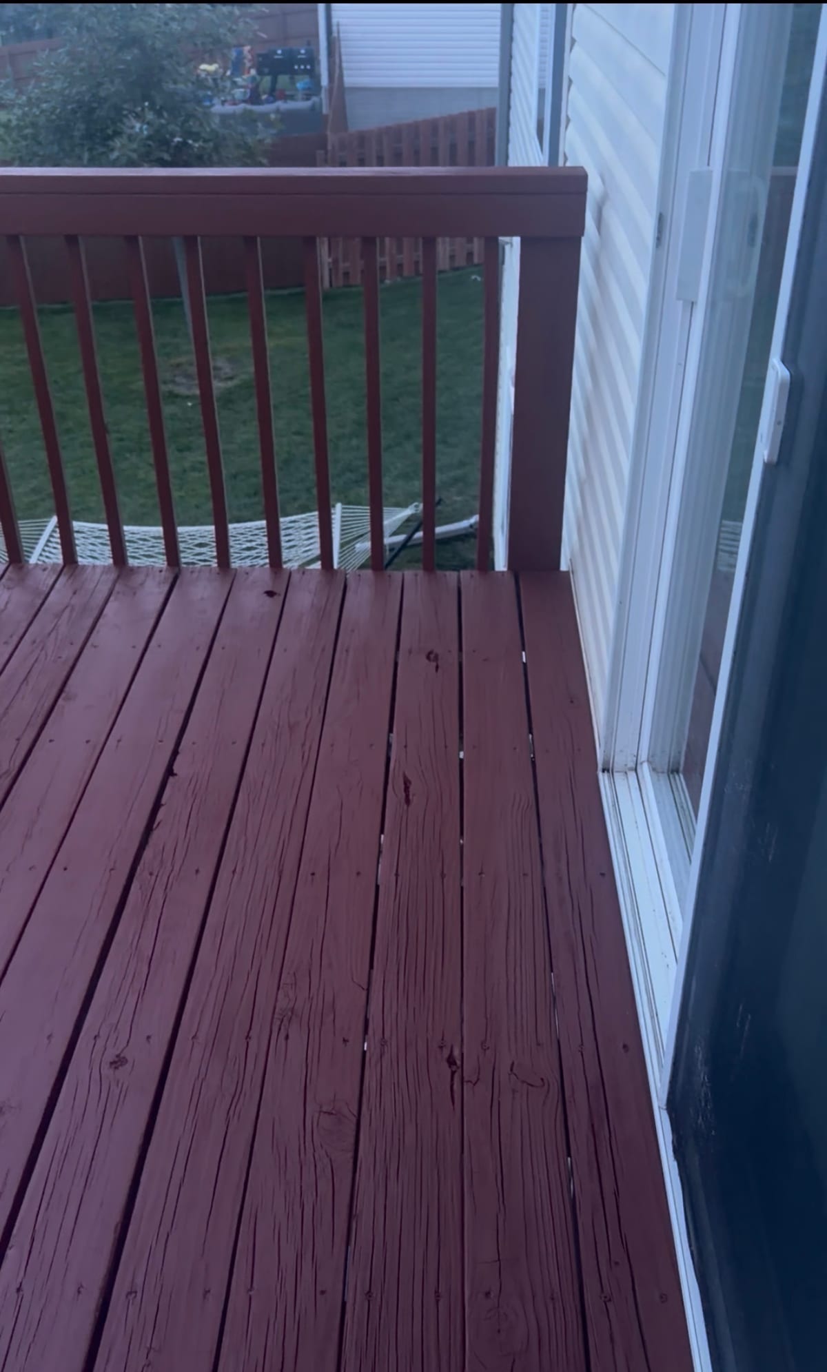 Freshly cleaned, stained, and sealed wooden backyard deck in Nebraska